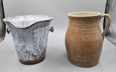 two vases sitting next to each other on a table
