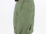 a green jacket with a fur collar on a mannequin head