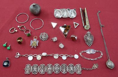 a lot of silver jewelry on a red table
