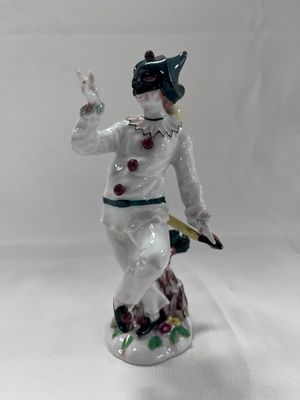 a figurine of a man with a knife in his hand