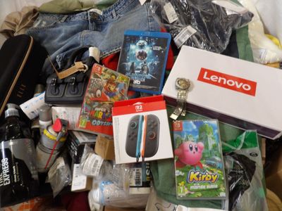 a pile of items that include a nintendo wii, a nintendo wii game controller, a nintendo wii game controller, a nintendo wii controller, and other items