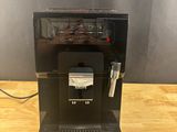 the coffee machine is sitting on the table ready to be used