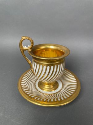 a cup and saucer on a saucer on a table