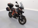a motorcycle parked in a room with a white wall
