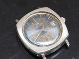 a silver watch with a blue face on a black surface