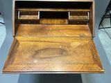 a wooden desk with a drawer on top of it