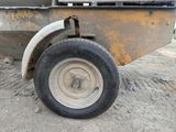 a wheel on the back of a dump truck