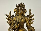 brass statue of a woman with a bird on her arm