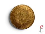 a close up of a gold coin on a white surface