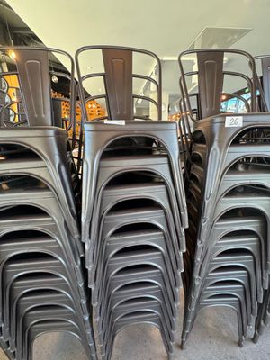 de nombreuses chaises empilées les unes sur les autres dans une pièce