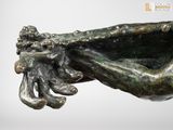 a bronze statue of a hand holding a bowl