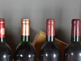 several bottles of wine are lined up on a table