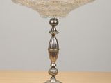 a close up of a silver plate on a wooden table