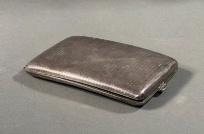 a silver cigarette case sitting on a table