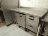 a kitchen with a lot of stainless steel counter tops