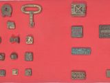 a red wall with a bunch of different type of metal items on it