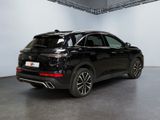 the rear view of a black suv parked in a garage
