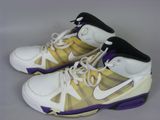 purple and white basketball shoes with purple accents on a gray surface