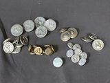 a pile of coins and a pair of scissors on a table
