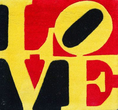 a close up of a red, yellow and black rug with the word love on it