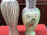 two vases that are sitting on a red table