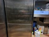 a stainless steel refrigerator sitting in a kitchen next to a counter