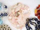 a lot of different colored beads on a white surface