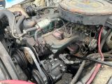 a close up of a car engine with the hood open
