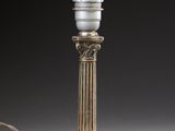 an antique silver plated table lamp with a white glass shade
