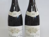 two bottles of wine sitting next to each other on a table
