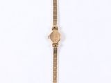 a close up of a wrist watch on a white surface