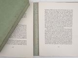a green book open on a white table