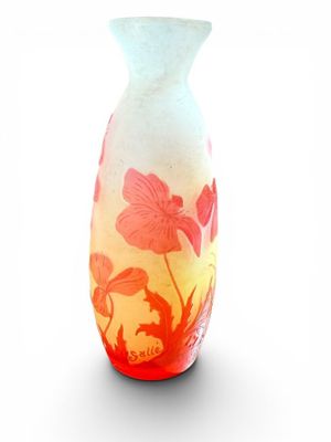 a glass vase with a red and yellow design on it