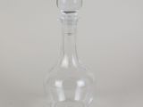 a clear glass bottle with a small glass stopper on it
