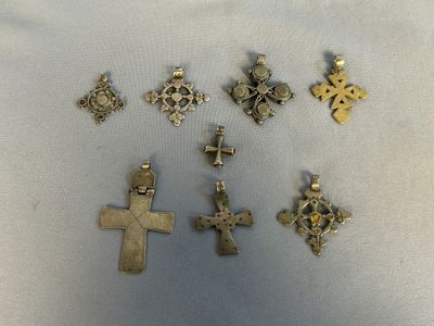 a close up of a group of crosses on a white surface