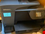 an image of a printer and a cell phone on a desk