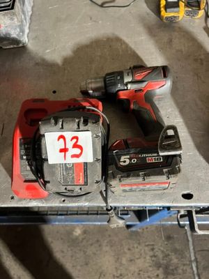 two tools are sitting on top of a table in a garage