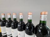 several bottles of wine are lined up on a table