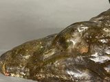 a statue of a bird sitting on top of a rock