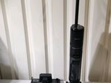 a black vacuum on a white table next to a white wall