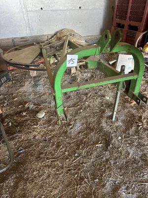 a green machine that is sitting in the dirt