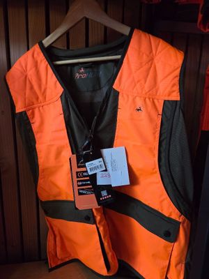 an orange vest with a tag on it hanging on a rack