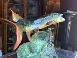 two fish sculptures on a clear table in a room