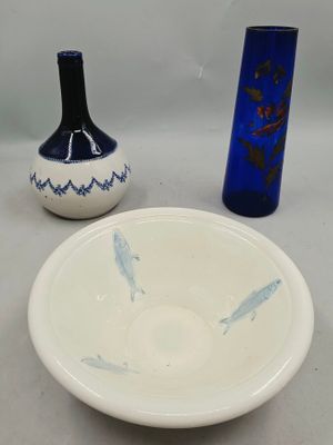 two vases and a bowl sitting on a table