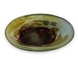 a bowl with a brown substance in it on a white surface