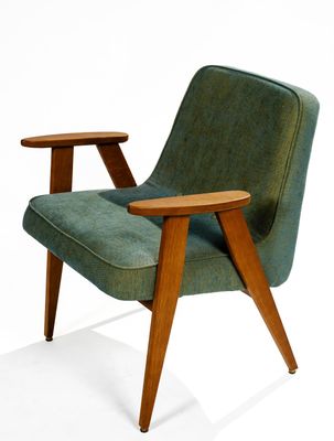 une image représentant une chaise verte avec des pieds en bois et un accoudoir en bois