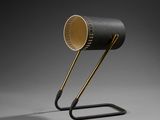a black table lamp with a gold shade on top of it