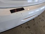 a close up of a white car with a sticker on it