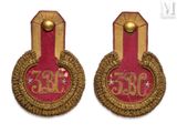 pair of red and gold embroidered badges with gold trims