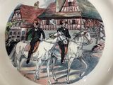 a plate with a picture of a man riding a horse